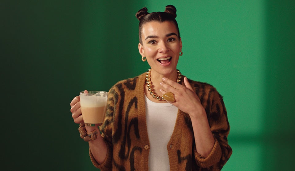 Young woman holding a cup of Starbucks® Pumpkin Spice Latte