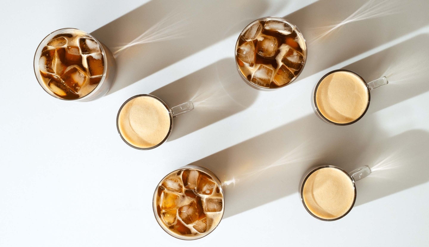 A top views of Starbucks® by Nespresso® coffees with bright light casting shadows and creating beautiful refractions.