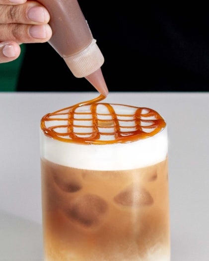 Caramel Drizzle on Coffee Latte Cup