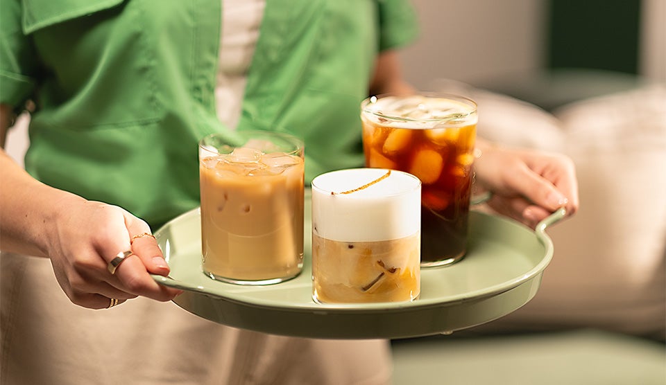 Three plastic cups with cold coffee