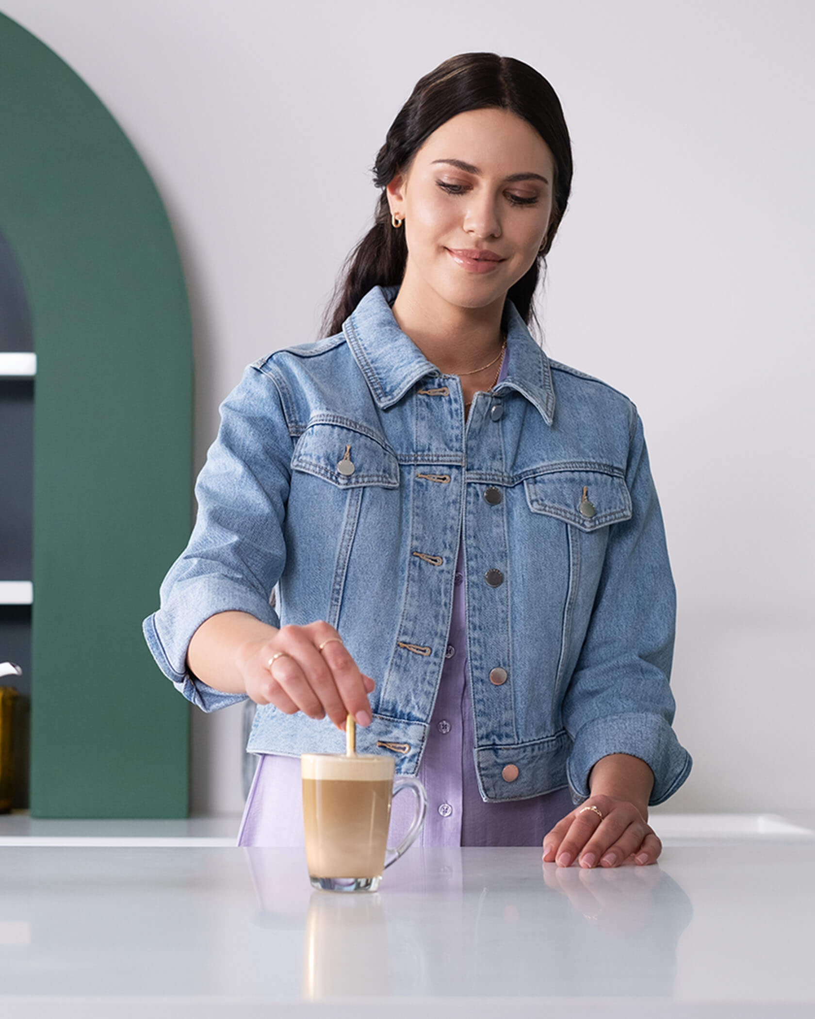 Woman making Starbucks® Caramel Latte Premium Instant