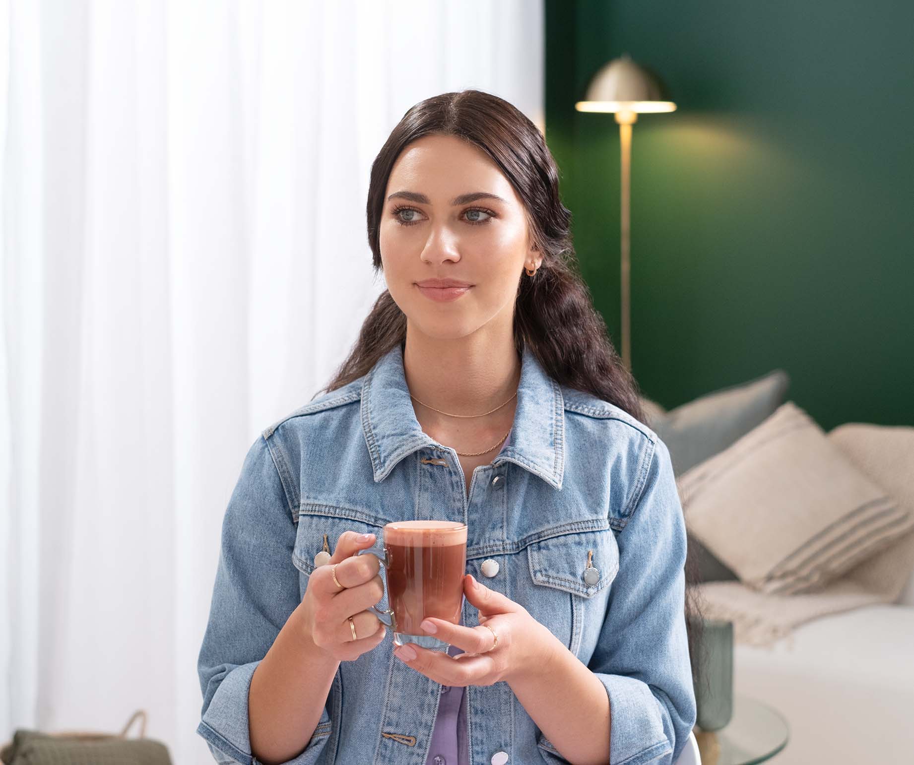 Woman enjoying Starbucks® Caffè Mocha Premium Instant Coffee