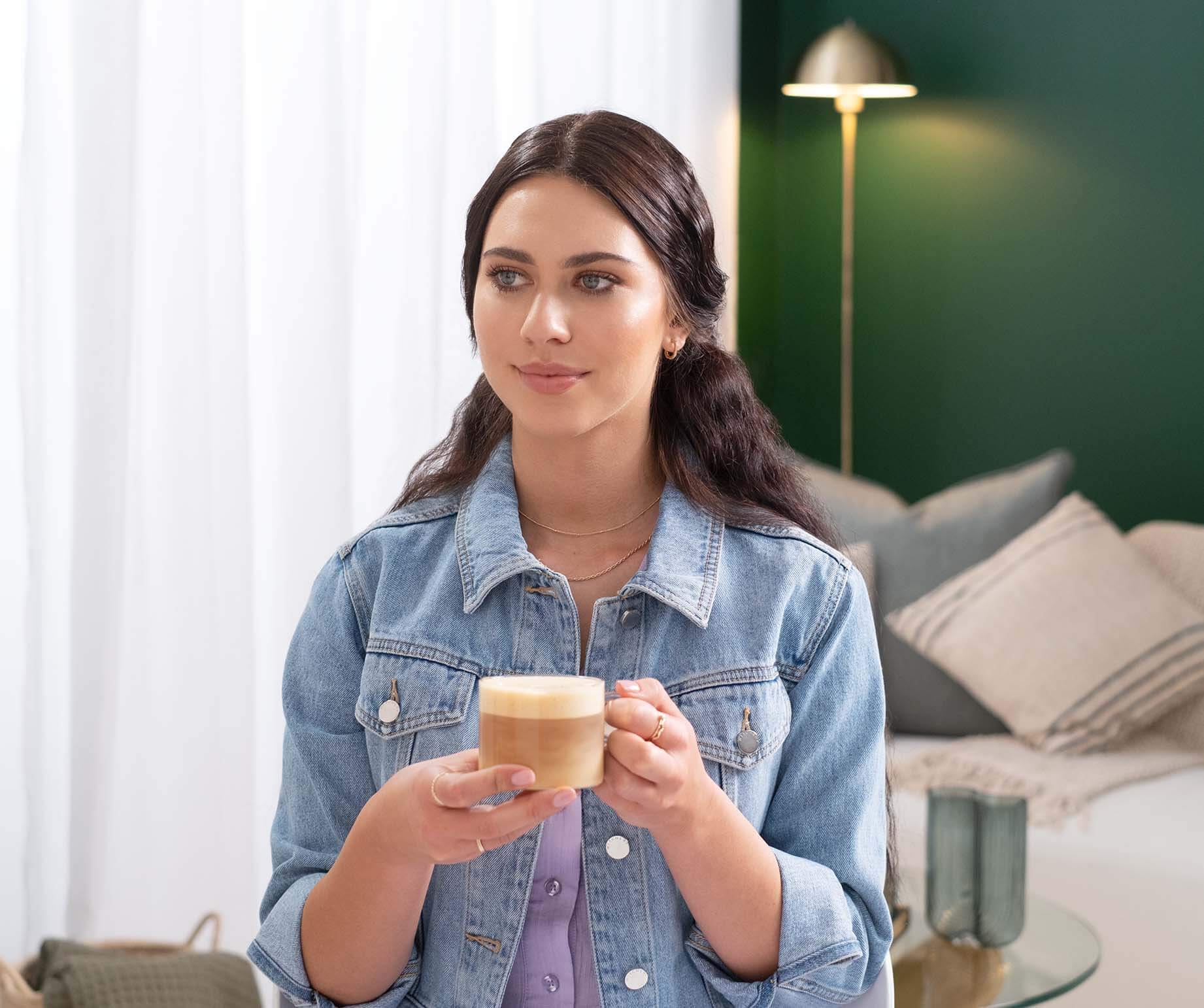 Woman enjoying Starbucks® Cappuccino Premium Instant Coffee