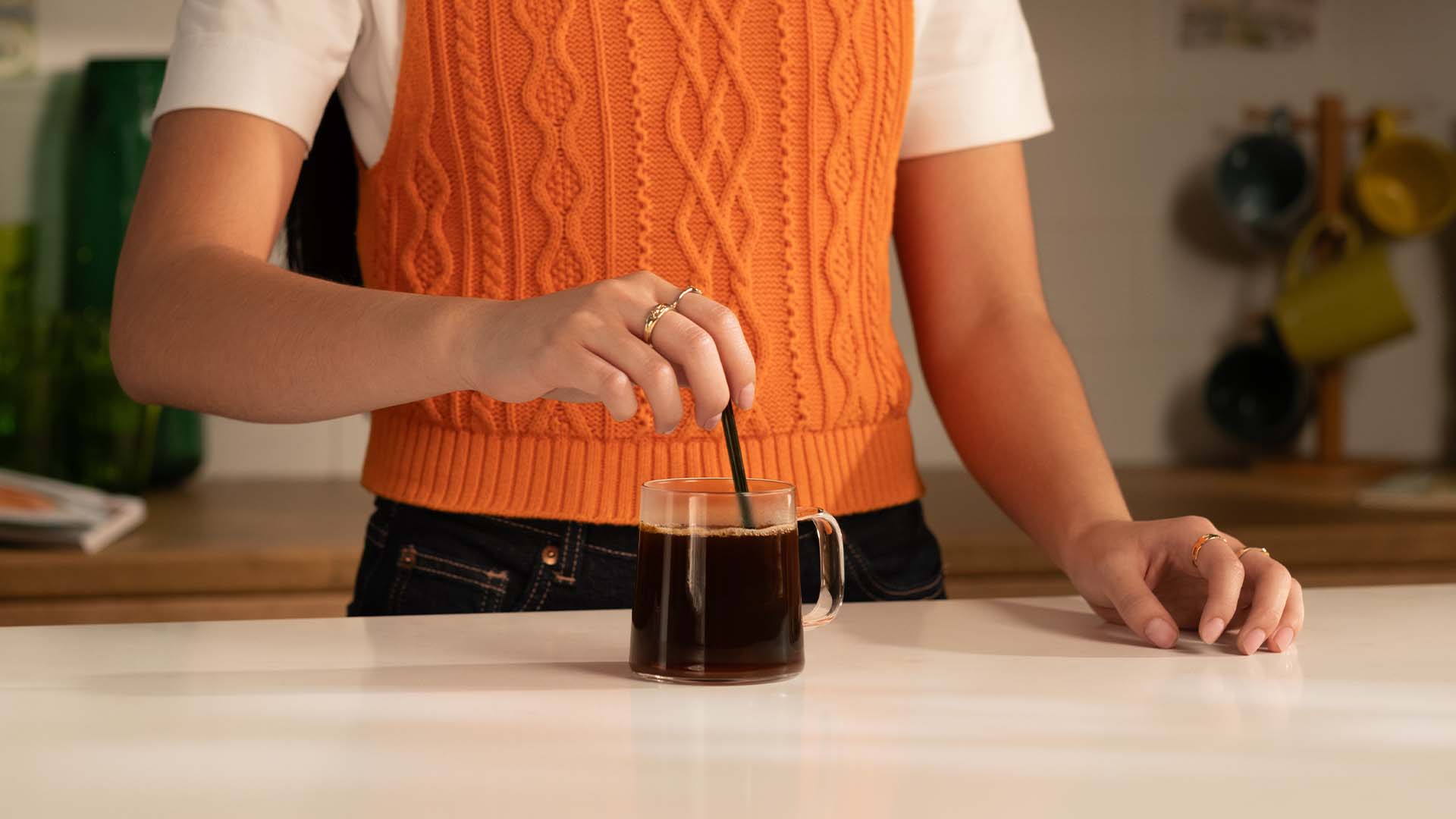 Soluble coffee being stirred inside a glass