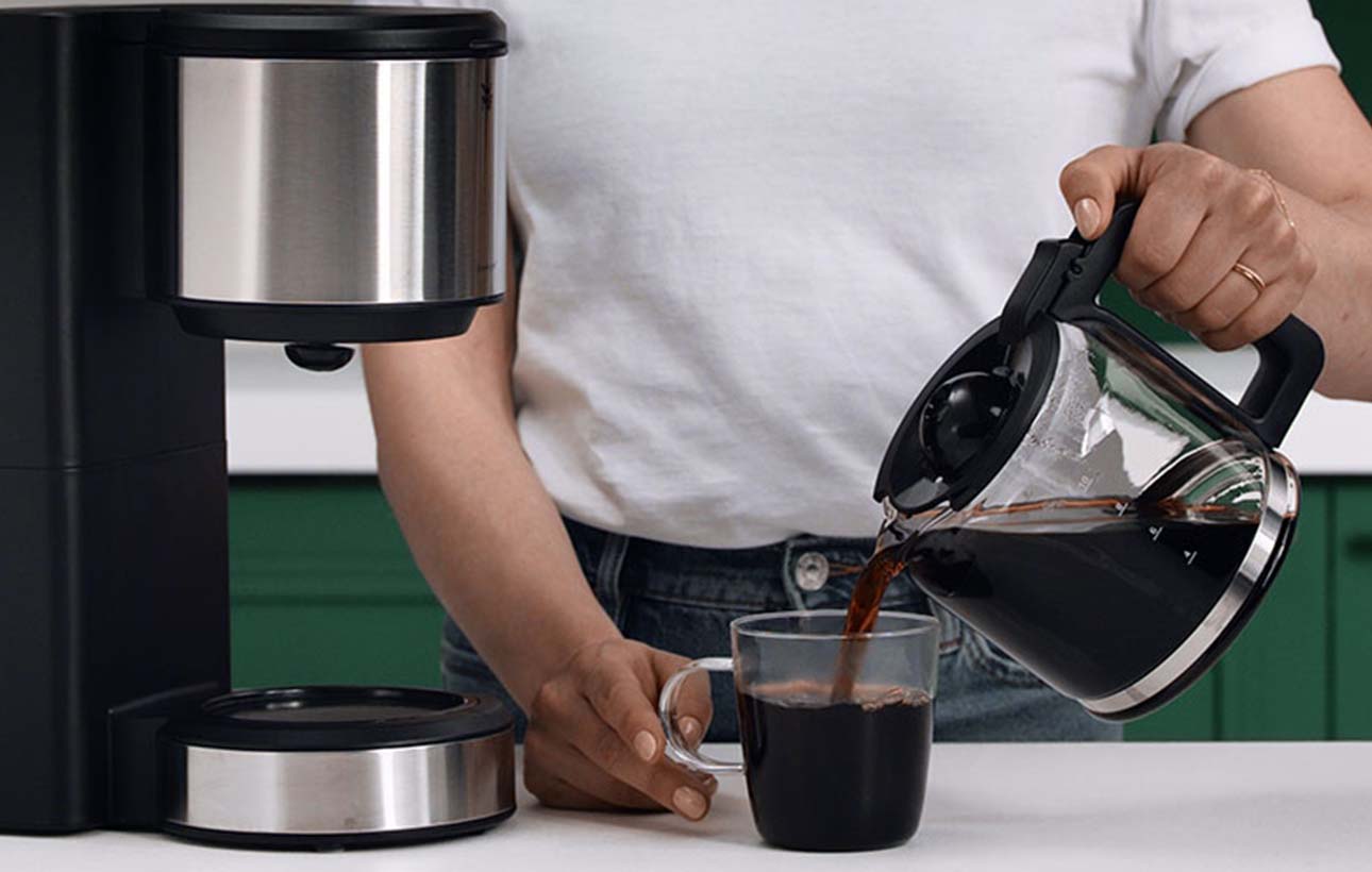 Pouring fresh coffee into a cup
