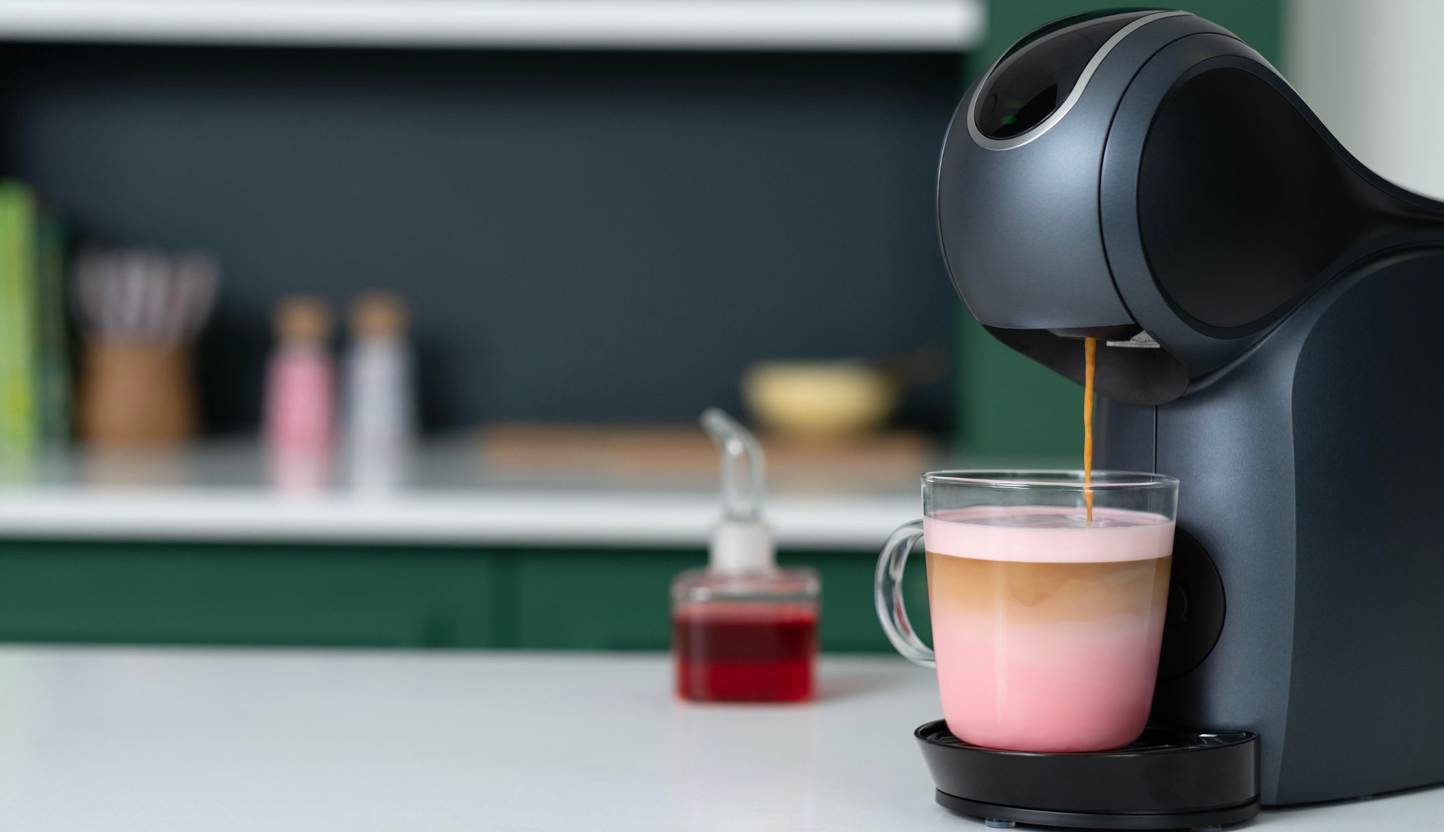 Fresh coffee is brewed over pink milk to create a colourful layered coffee.
