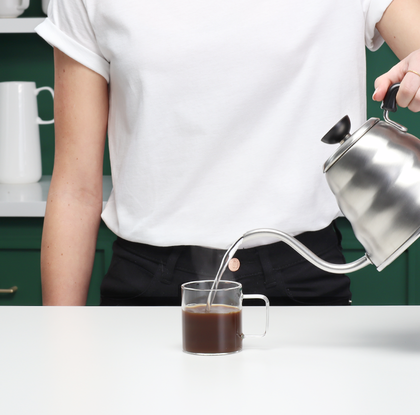 Pour 180 ml hot water into the mug.