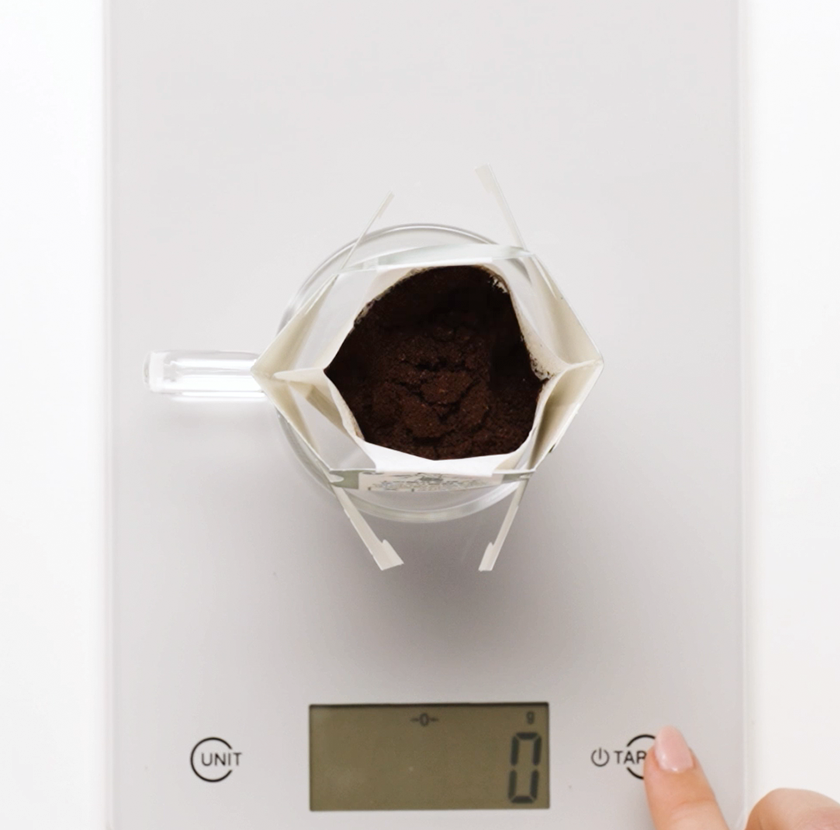 Place the Starbucks® Origami™ filter on top of your mug, with the coffee filter over the centre. 