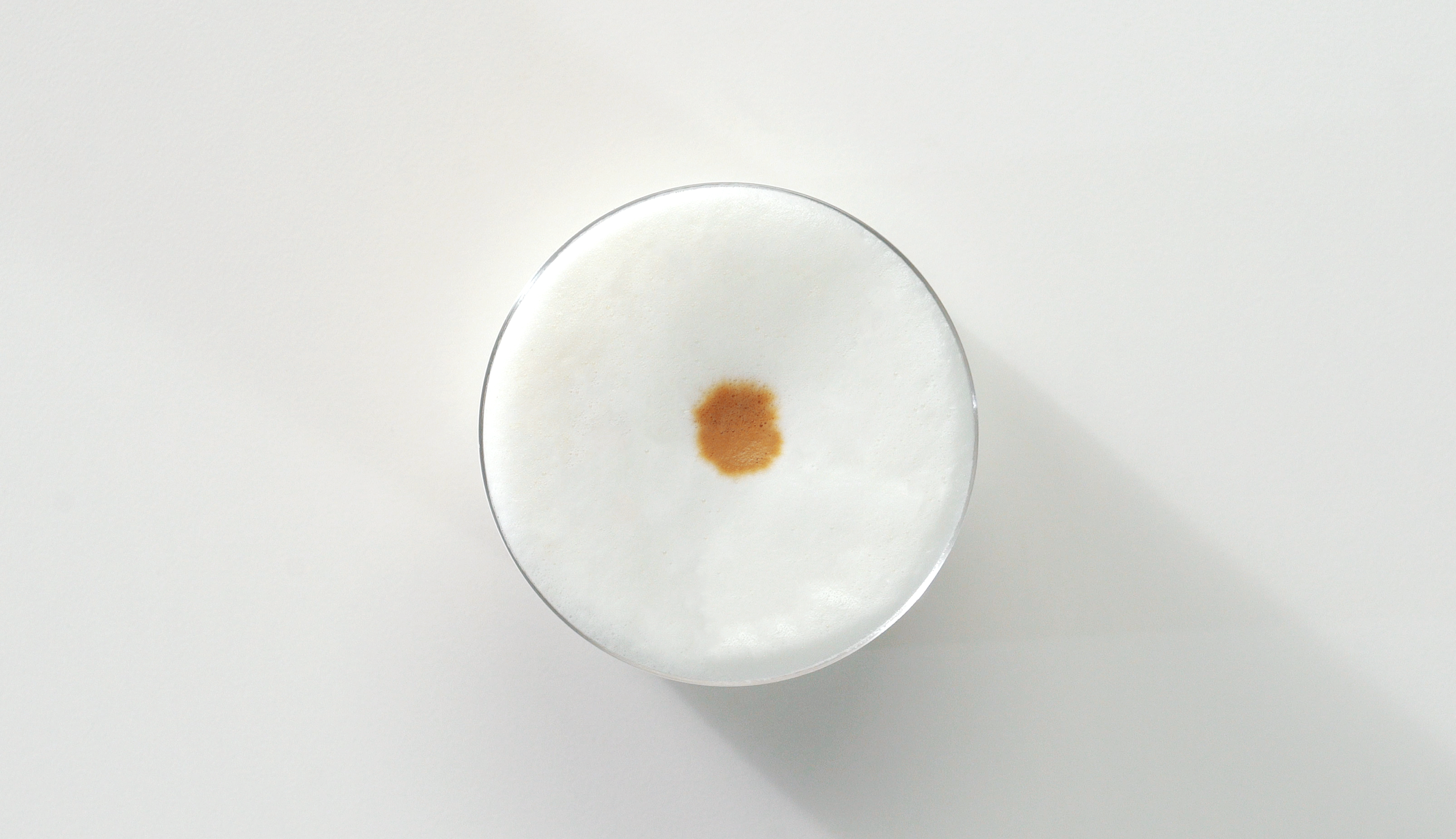 Top view of frothy milk on an iced Starbucks® coffee.