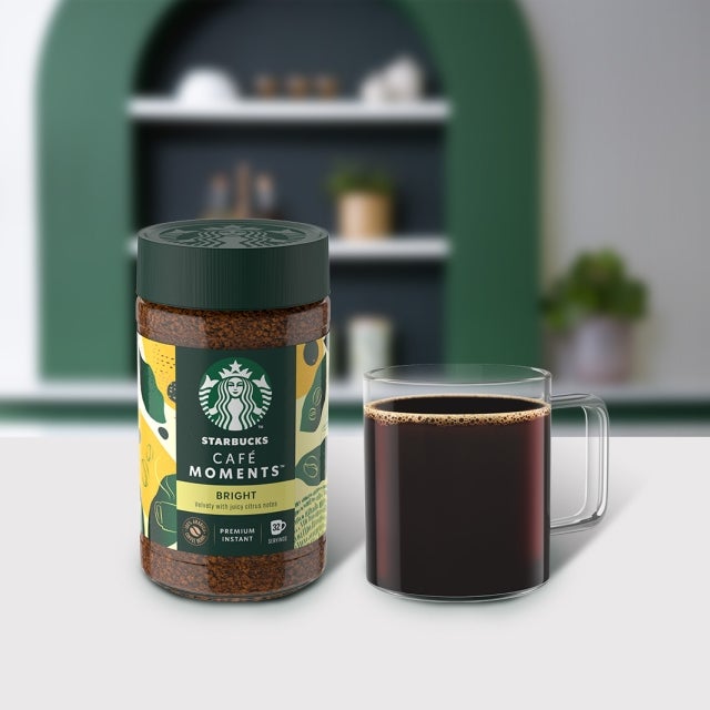 Starbucks® Cafe Moments Bright package next to a coffee glass