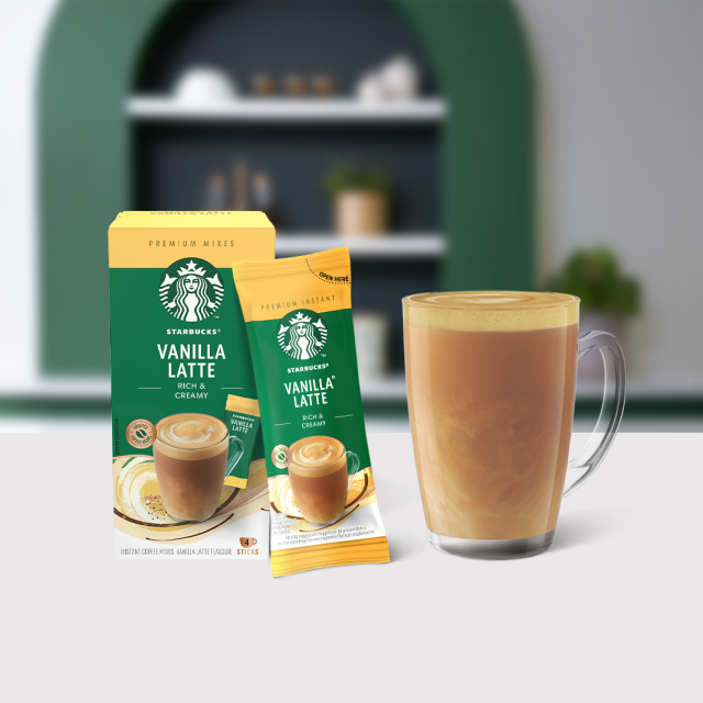 Starbucks® Vanilla Latte Premium Instant Coffee package next to a coffee glass
