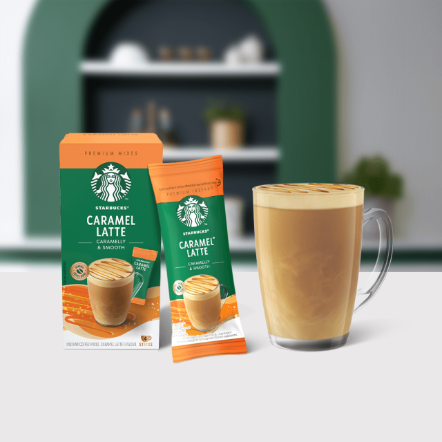Starbucks® Caramel Latte Premium Instant Coffee package next to a coffee glass
