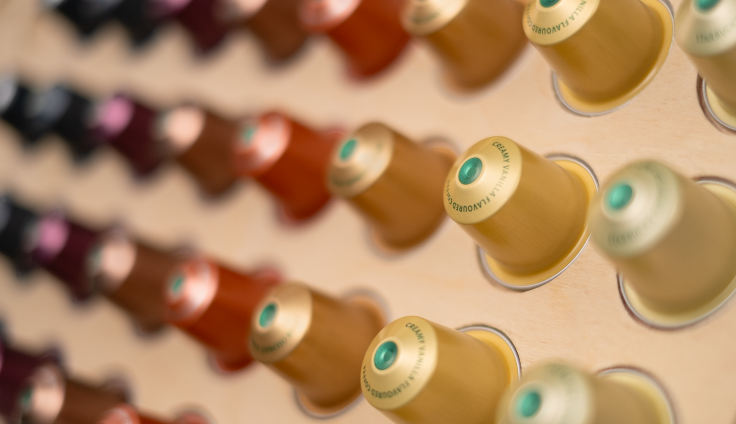 Brewing cabinet full of coffee capsules, roast coffee and accessories